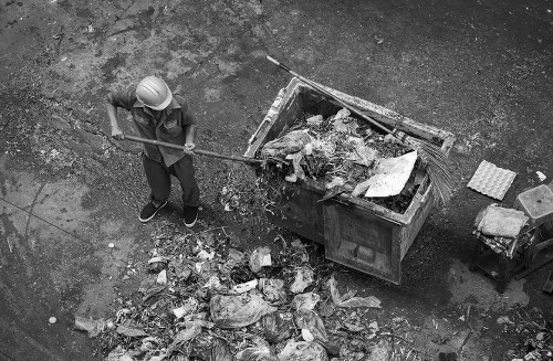Standard skip being loaded with construction materials